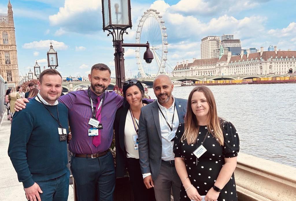 Staff and officers stood at the bank of the river Thames