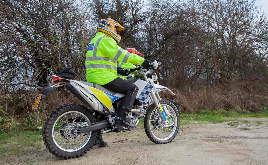 Police officer riding off road bike