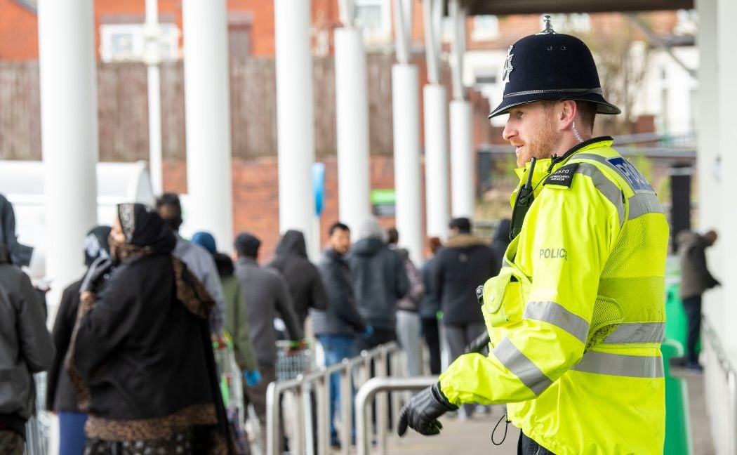 Police officer stood outside shop