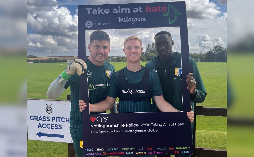 Mansfield Town players Christy Pym, Davis Keillor-Dunn and Lucas Akins holding take aim at hate frame