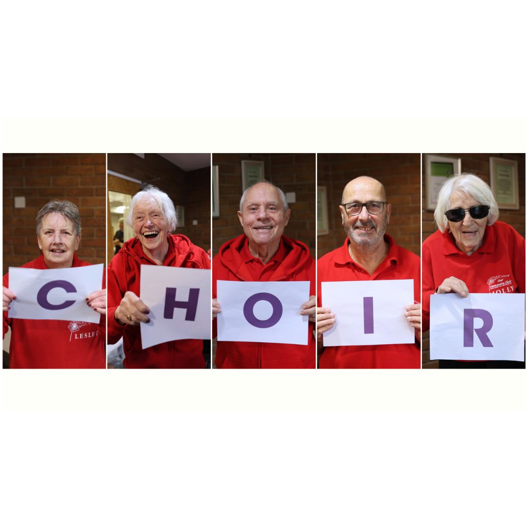Members of Vicky McClure’s Our Dementia Choir hold up 'CHOIR' lettering