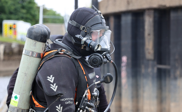 Police diver in diving kit and mask on 