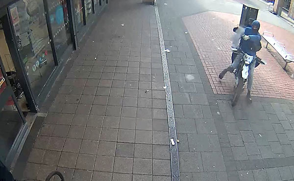 Two people on a bike fire guns
