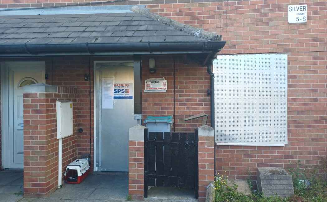 Front door of property is boarded up
