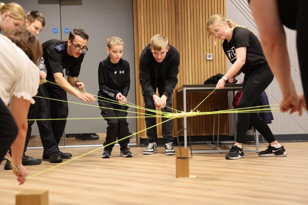 A group of cadets take part in a team-building game.