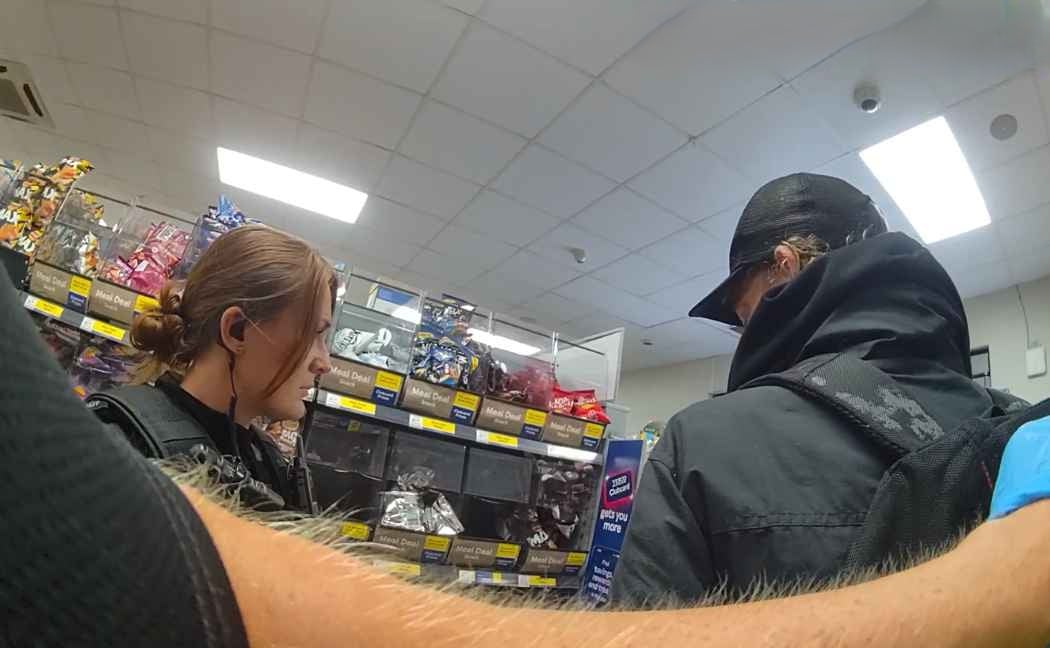 Neil Jenkins pictured being arrested inside the shop