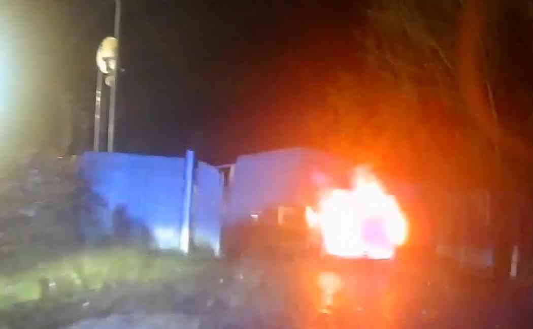 Van crashes through gates