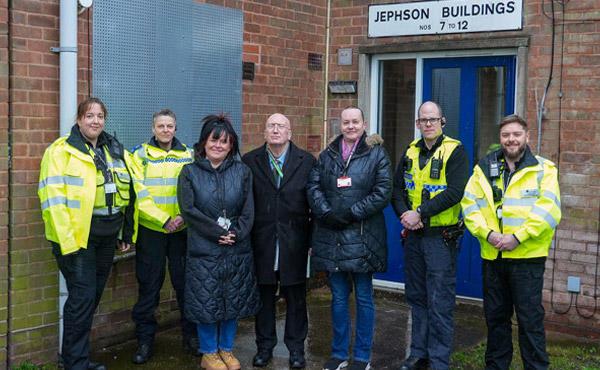 Police, community protection  officers, and councillors stood outside a building