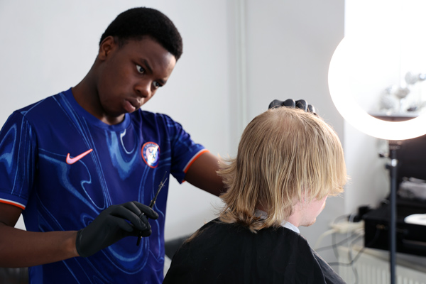 20260514-Joel-Mbakop-cutting-hair.jpg