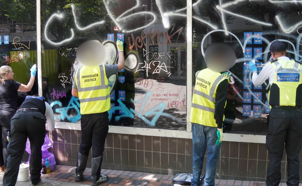 Young people clearing up graffiti in the city centre