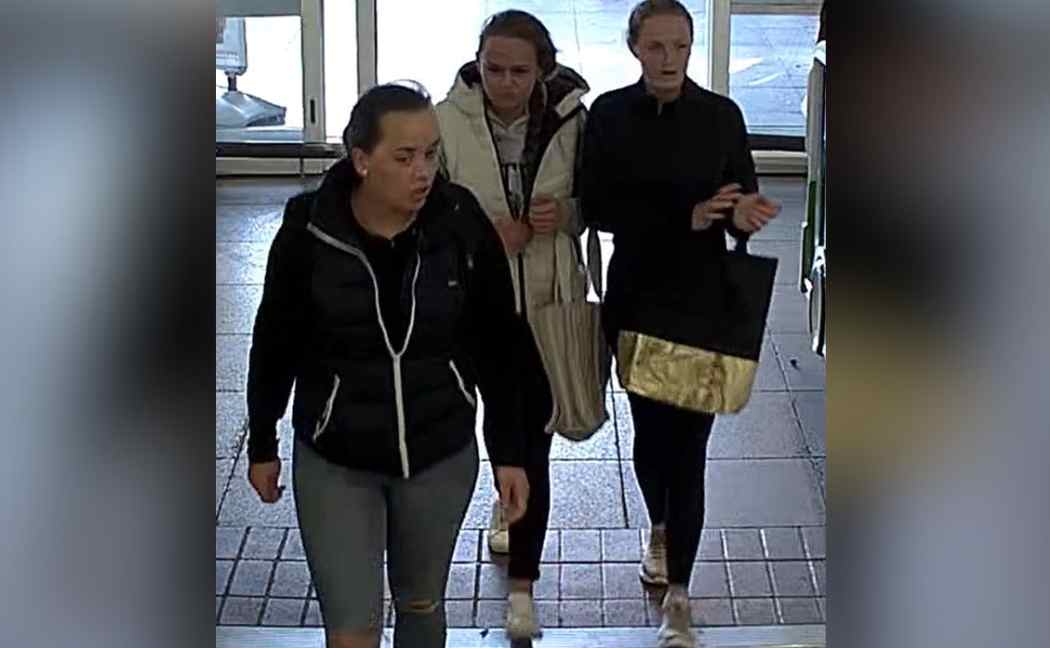 Three women walk into shop