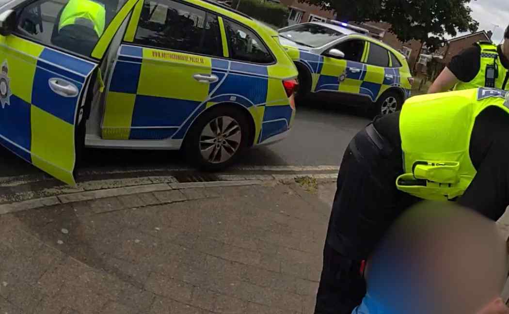 Suspect sat on the floor is arrested by officers