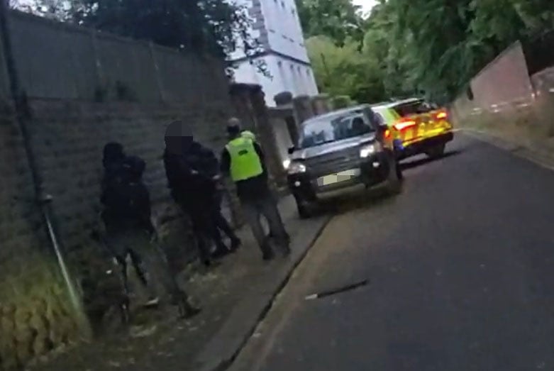 Police officers arresting two suspects