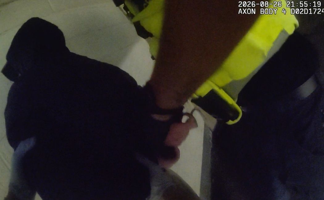 One of the suspects is handcuffed by officers