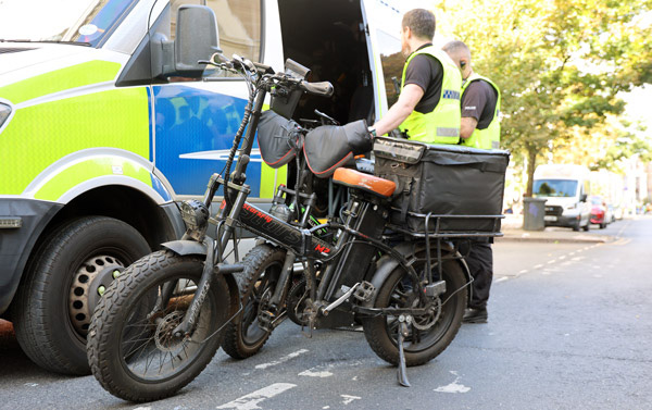 Police officers seizing an e-bike in Nottingham city centre