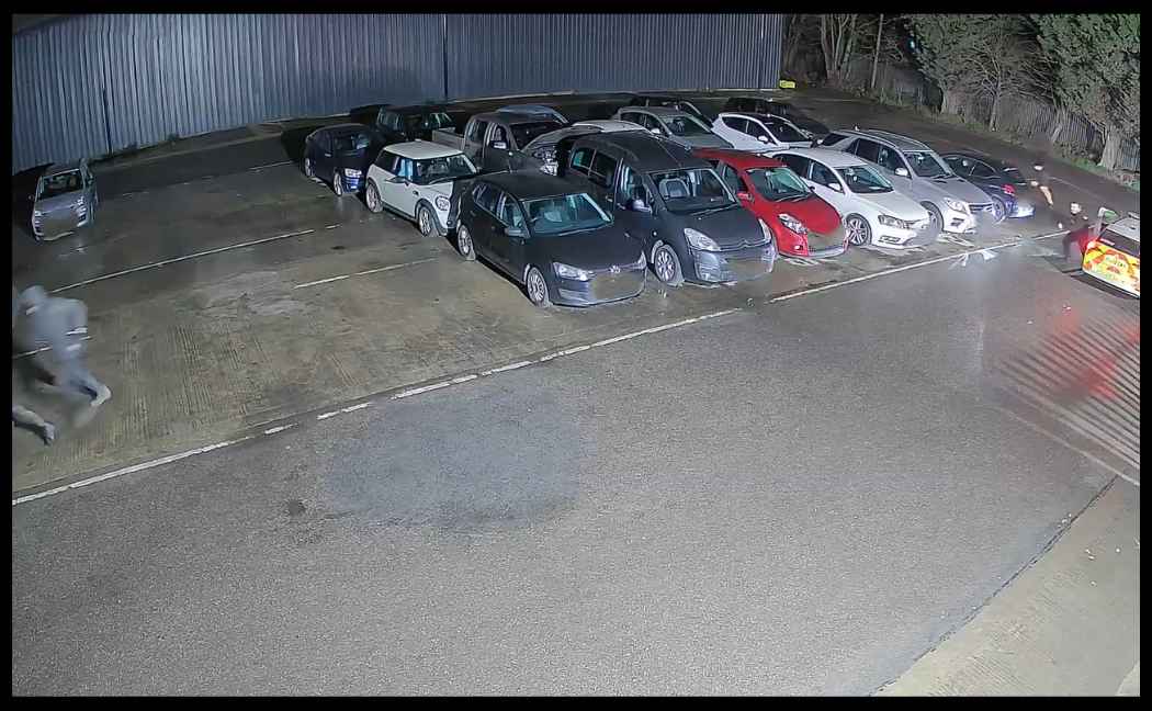 Officer starts chasing suspect across car dealership